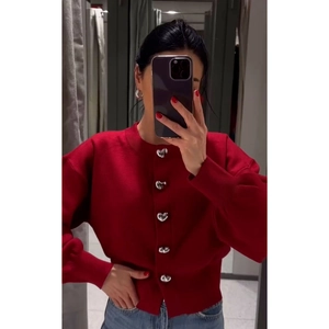 Red knit cardigan for women with decorative silver heart-shaped buttons and round neck