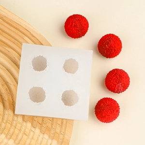 Close-up of 4-cavity white silicone mold with realistic lychee texture for cake decorating