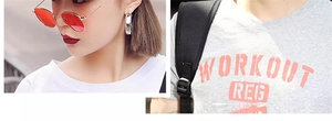 Detail of silver hoop earrings and grey crew neck t-shirt with red Workout print