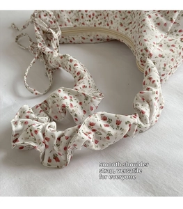 Detail of floral tote bag showing tulip print and scrunchie style ruched shoulder strap