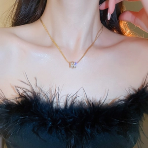 Close-up of gold-plated multi-layer zircon cylinder pendant necklace on model