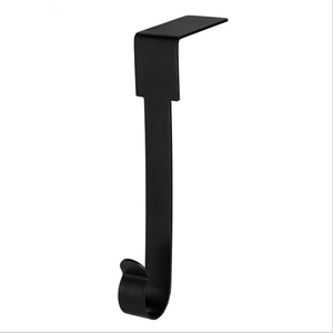 Detail of a sleek black metal fireplace stocking hanger with a sturdy J-shaped hook design