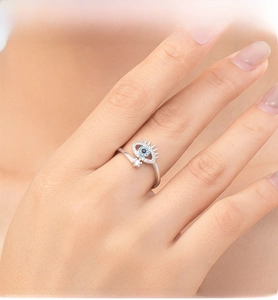 Macro detail of S925 silver Evil Eye open ring with micro-pave blue and white zircons