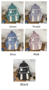 Detail view of colorful cartoon backpacks with plush rabbit ears and side pockets