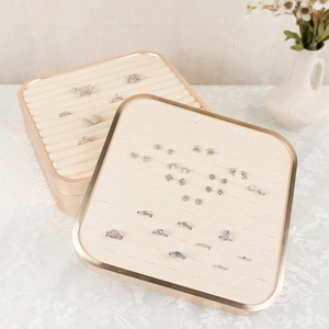 Champagne gold metal jewelry tray with cream velvet lining for rings and earrings display