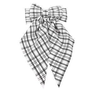 Detail view of the multi-layered black and white checkered bow clip with long ribbons
