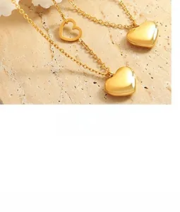 Detailed macro view of gold heart necklace set with polished and hollow heart pendants