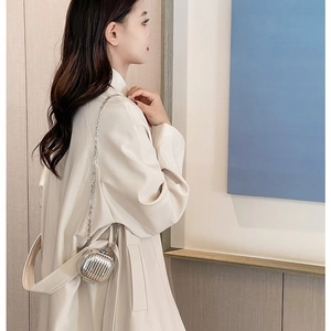Mini silver metallic chain bag with ribbed hardshell design shown on model shoulder