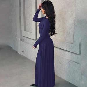 Detail view of the slim-fit high-waisted dark purple maxi dress with long sleeves