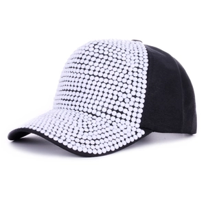 Detail of black baseball cap with white pearl decorations and elegant side profile view
