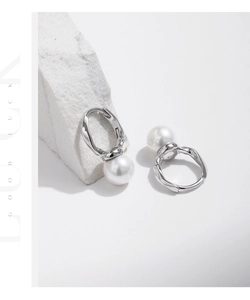 Macro view of S925 sterling silver earring detail with irregular texture and pearl