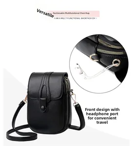 Detail of black pebbled leather mini crossbody bag featuring a functional earphone port