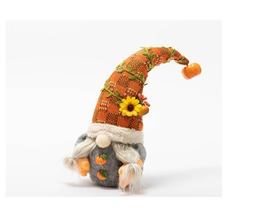 Detail of harvest gnome doll with orange plaid hat and sunflower pumpkin decorations