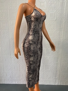 Detail of cross straps and V-neck design on a snakeskin print midi bodycon dress