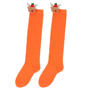 Detail of vibrant orange knitted Christmas socks featuring 3D reindeer doll ornaments