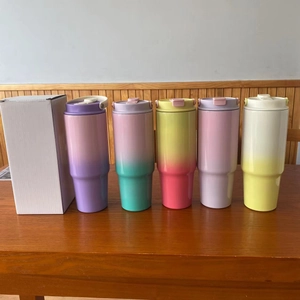 Detailed row of five 30oz insulated tumbler cups with colorful gradient finishes on wood