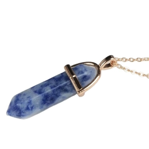 Natural hexagonal column stone necklace with golden chain on white background