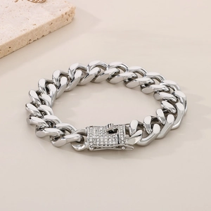 Detailed macro view of silver Cuban link bracelet with sparkling diamond-set square clasp