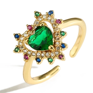 Detail of 18K gold plated heart ring with emerald green zircon and multi-color stones