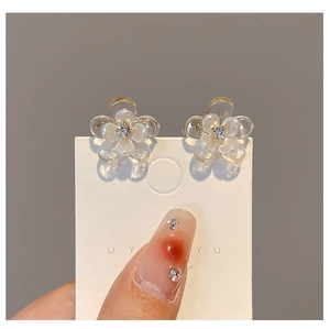 Macro shot of mini camellia flower hair clips with clear rhinestones on petals