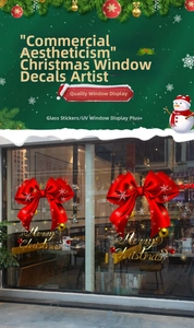 Detail showing red ribbon bows and golden Merry Christmas window stickers for festive shop decor