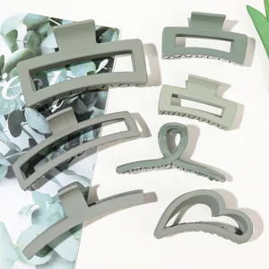 Detailed set of matte sage green hair claws in diverse geometric shapes for hair styling