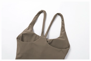 Detail of ribbed brown yoga top showing high-quality stitching and elastic fabric texture