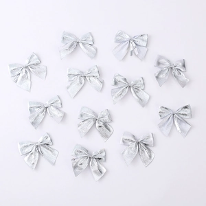 Detailed view of twelve silver metallic bows for Christmas tree decoration and DIY crafts