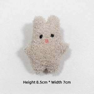 Detail view of plush bunny accessory with dimensions 8.5cm by 7cm in soft teddy fleece