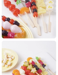 Detailed view of colorful artificial mixed fruit skewers including strawberry and kiwi models