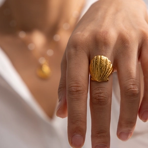Macro detail of wave shell texture on a 18K gold plated stainless steel ring