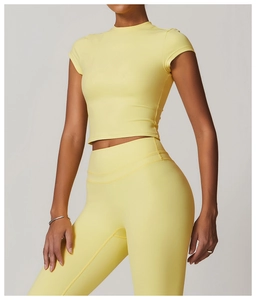 Close-up of tight-fit pale yellow sports top featuring high-quality flat-lock stitching