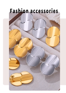 Detailed view of minimalist curved teardrop stud earrings in gold and silver finishes