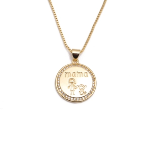 Macro shot of gold MOM pendant with crystals and mother-child engraving for gift
