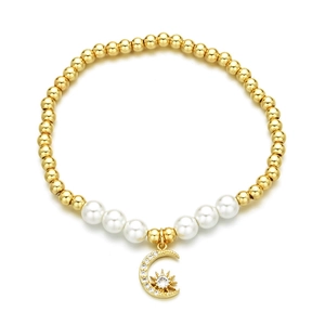 Golden bead and pearl stretch bracelet featuring a moon and star zircon pendant