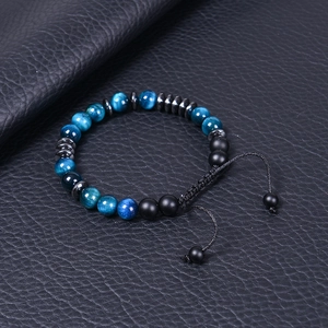 Detail of adjustable braided cord on tiger eye and black stone beaded bracelet