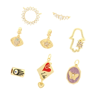 Golden DIY jewelry charms with zircon and enamel heart pendants and evil eye palm designs
