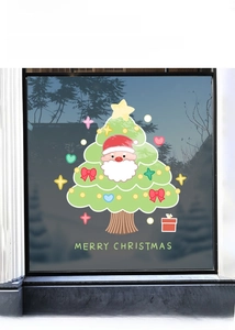 Close-up of static Christmas tree window sticker with Santa Claus and festive decorations