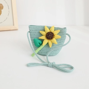 Close-up of a light blue woven crossbody bag with yellow sunflower for children
