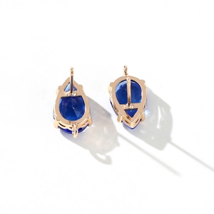 Detailed view of blue teardrop gemstone earrings with gold plated 14k brass hooks