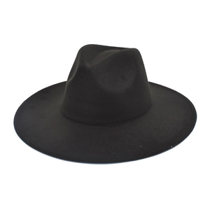 Detailed view of the wide brim and pinch crown design of a classic black wool fedora hat
