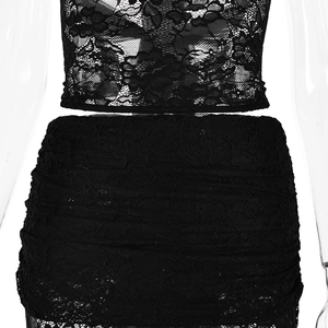 Close-up of intricate black lace texture on sexy two-piece crop top and skirt set