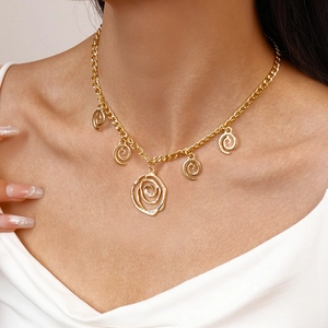 Close-up of artistic gold-plated spiral flower necklace on model for a vintage look