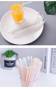 Macro shot of flexible striped plastic straws in a glass of juice with bundle view