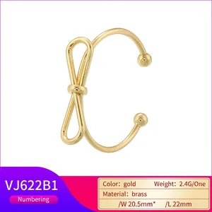 Elegant gold bow-shaped adjustable open ring crafted in brass with a minimalist design