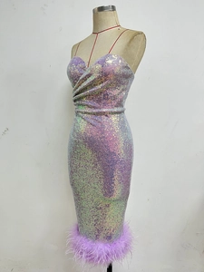 Detail of sequin evening dress featuring colorful shimmer and purple feather trim hem