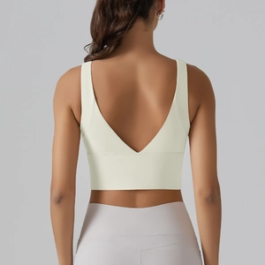Detailed back view of a pale yellow sports bra featuring a V-shaped open back and elastic fabric