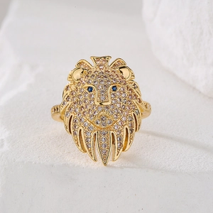 Gold lion head open ring with white cubic zirconia and blue sapphire eyes