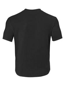 Close-up of black waffle textured fabric and breathable mesh on casual short sleeve T-shirt