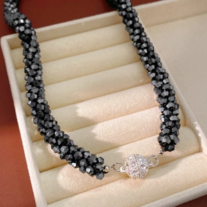 Close-up of black faceted beads necklace with a silver rhinestone-pave magnetic clasp